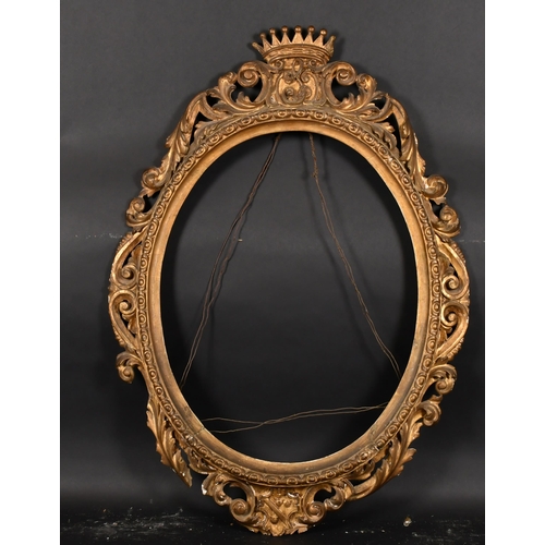 391 - 19th Century Italian School. An Ornate Oval Carved Giltwood Florentine Frame, rebate 29” x 23” (73.7... 