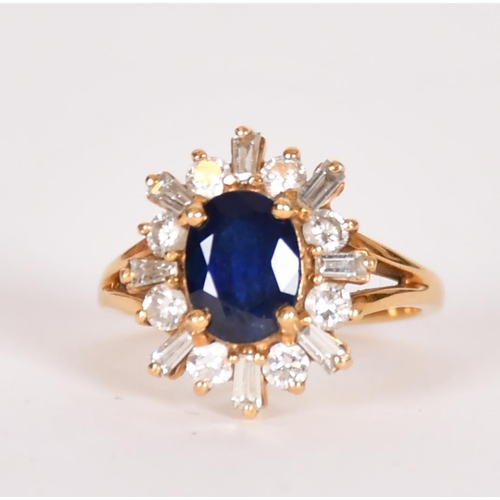 339 - Sapphire and diamond cluster ring, the central oval sapphire within a border of brilliant and baguet... 