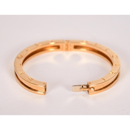 343 - Bulgari  gold hinged  bangle, signed and marks for 18ct gold, 53 x 45mm 42grams, internal measuremen... 