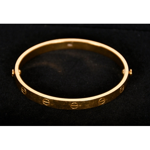 344 - Cartier Love bangle, designed as a manacle, signed, marks for 18ct, 39.7 grams. Complete with screwd... 