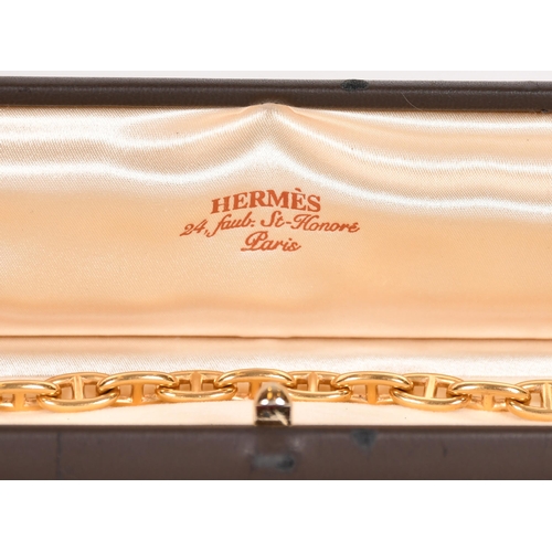 345 - Hermes gold bracelet, composed of stirrup links to a gold T bar, French control marks, and English H... 