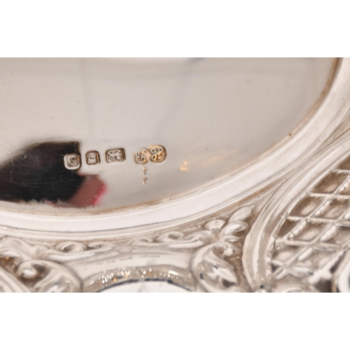 362 - A small silver photograph frame and a small silver oval dish