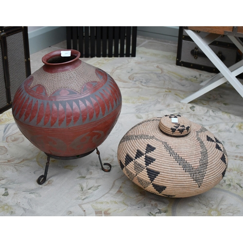 377 - A native American Indian pot with incised decoration (on a stand) and a basket weave pot with geomet... 