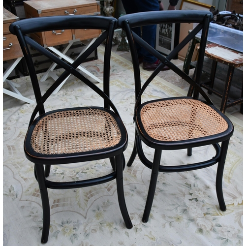 379 - A set of fourteen black bentwood dining chairs with caned seats (two seatpads slightly different) (1... 