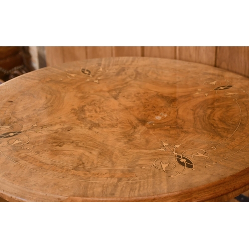 400 - Victorian pale walnut lamp table, the circular quarter section veneered top inlaid with satinwood an... 