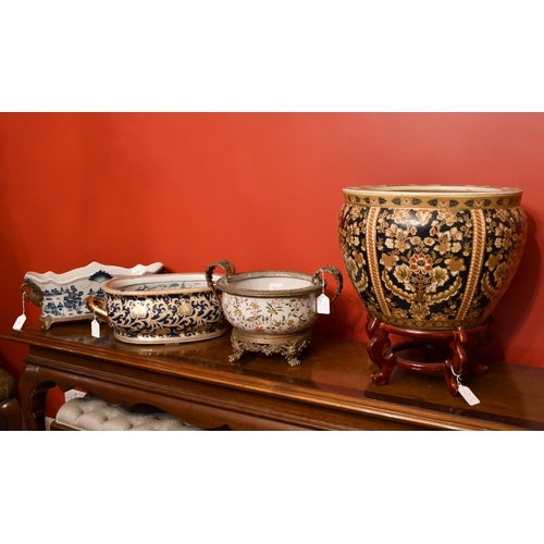 446 - A group of Oriental ceramics (two with gilt metal mounts) and a fishbowl, 44 x 38cm on a carved hard... 