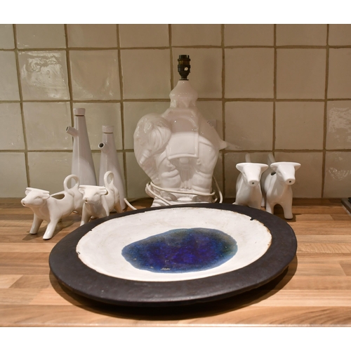 526 - A Studio Pottery glazed platter, elephant lamp base, oil bottles and cow creamers (8)