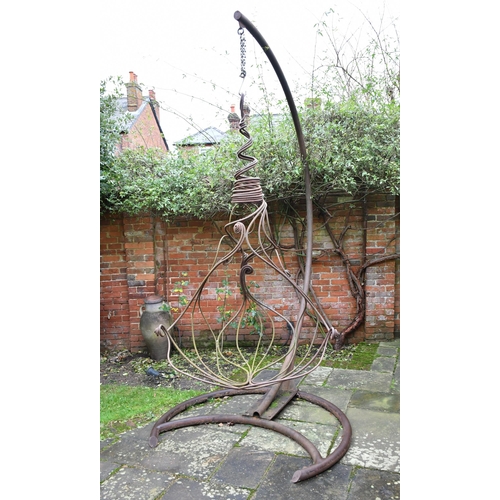 530 - A heavy wrought iron sculptural garden swing chair, 300 x 220cm max (please note this lot will need ... 