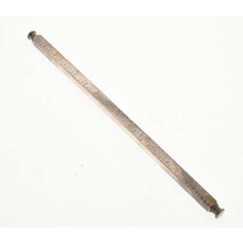 A white metal 8-inch ruler of rectangular form containing a propelling ...