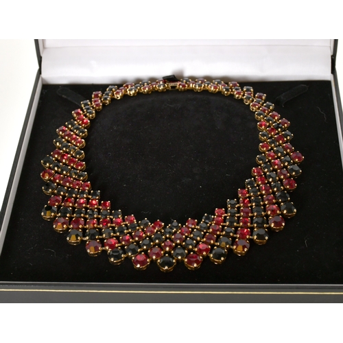 338 - Trifari: A Costume Gilt Black and Red Paste Bib Necklace, graduated and articulated with circular-cu... 