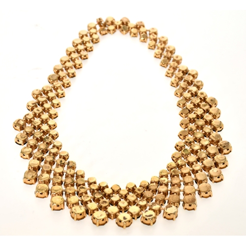 338 - Trifari: A Costume Gilt Black and Red Paste Bib Necklace, graduated and articulated with circular-cu... 