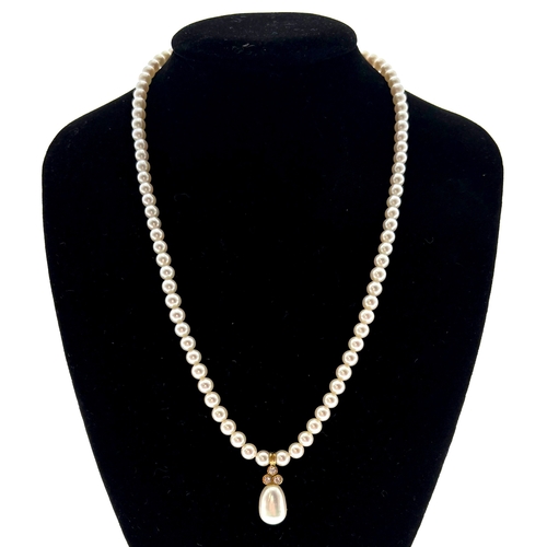 346 - A Single Row Cultured Pearl and Diamond Necklace, slightly graduated, measuring 4- 4.4 mm approx., s... 