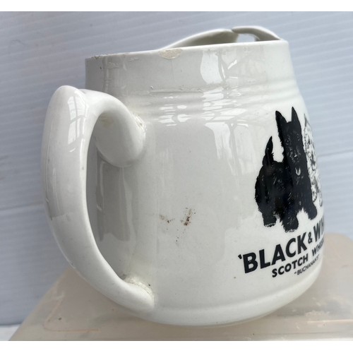 181 - ARKLOW POTTERY BLACK AND WHITE WHISKY JUSG IN GOOD CONDITION NO DAMAGE OR REPAIRS