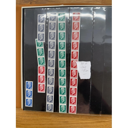 353 - GERMANY album containing a selection of coil strips, a few blocks and panes from East, West and Berl... 