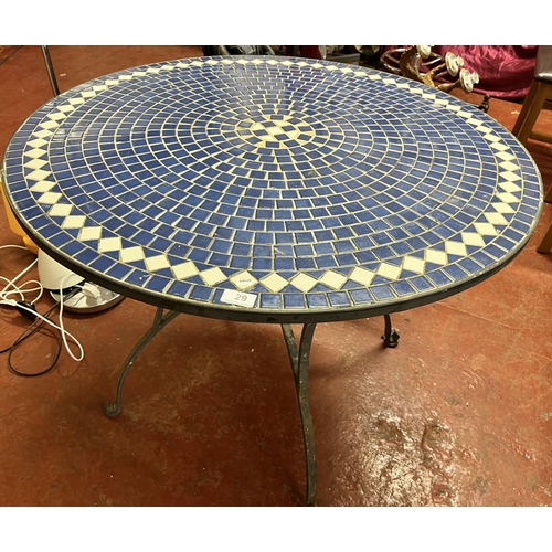 29 - LARGE CAST IRON BASE CIRCULAR BLUE & WHITE TILE TOP GARDEN TABLE