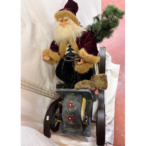 192 - ORNAMENTAL SANTA CLAUSE IN CAR(RESERVE £25)