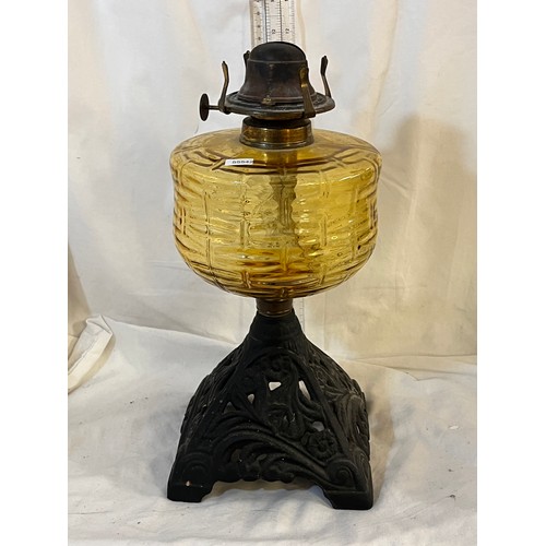 119 - ANTIQUE CAST IRON BASE OIL LAMP WITH AMBER GLASS