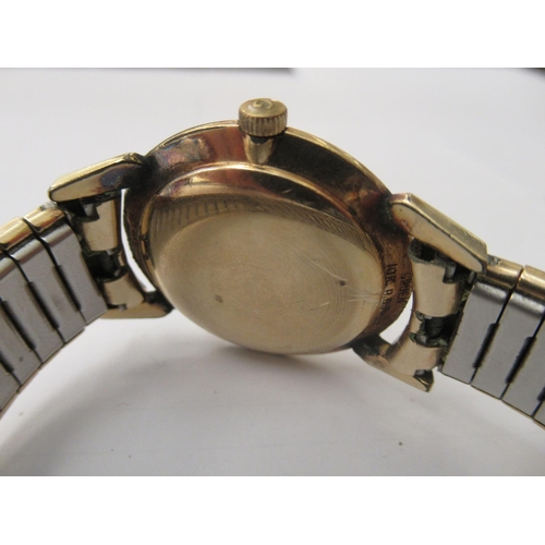 159 - A yellow metal curb link bracelet&nbsp; stamped 10k; and a Gruen gold plated manual wristwatch, face... 