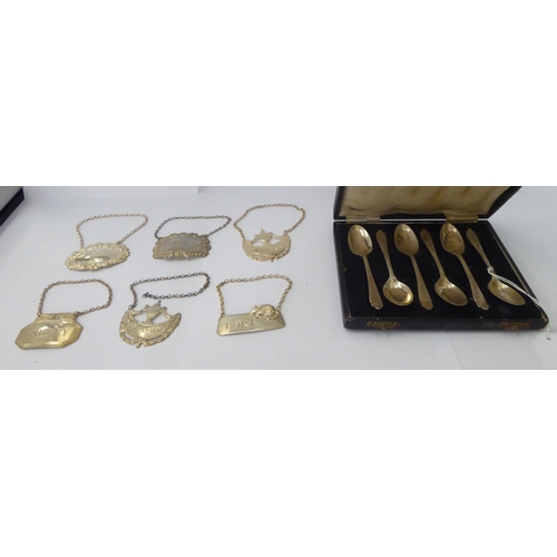 174 - Six silver decanter labels  mixed marks; and a set of six silver teaspoons  Sheffield 1948  cased
