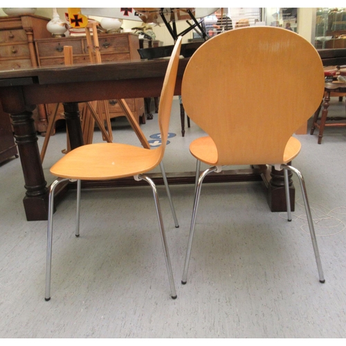 119 - A set of four Janik style light stained and curved plywood, stackable chairs, the one-piece backs ra... 