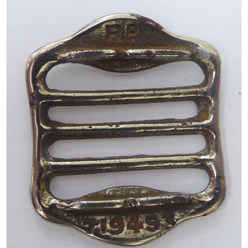 131 - Nazi collectables, viz. a white metal belt buckle, stamped with swastika emblems and Rd.719493; an 1... 