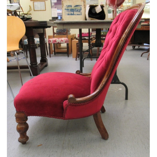 22 - A late Victorian mahogany showwood framed salon chair, the part button, red fabric upholstered back ... 