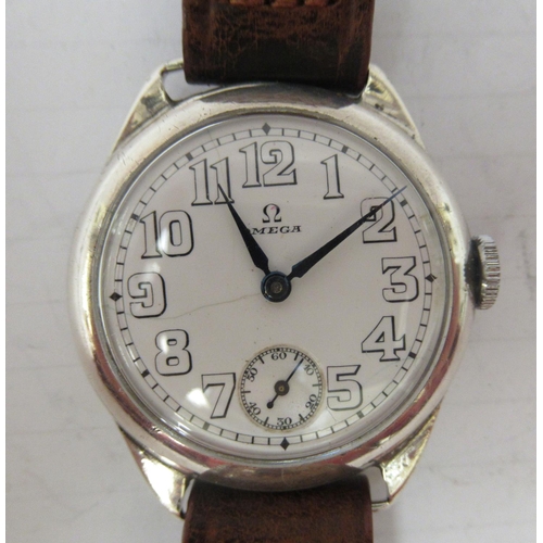 326 - An Omega, silver cased wristwatch, faced by an Arabic dial with subsidiary seconds, on a later brown... 