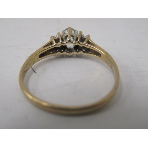 333 - A 9ct gold ring, set with a central aquamarine, flanked by small diamonds  