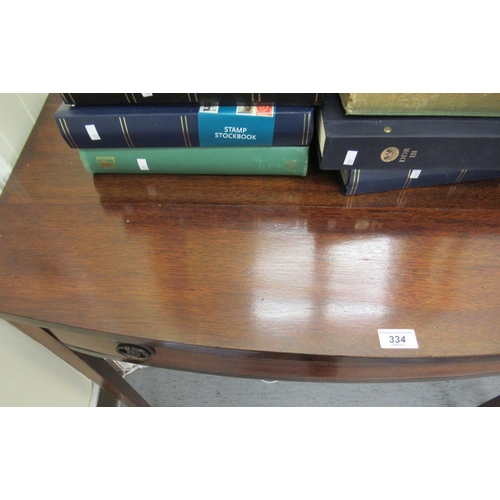 334 - An early 19thC mahogany bow front side table with a frieze drawer, raised on square, tapered legs&nb... 