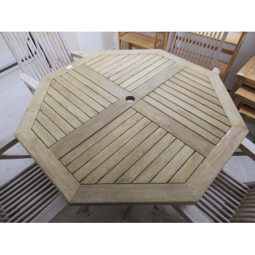 336 - A modern Lindsey teak garden table with a slatted octagonal top, raised on folding legs  30