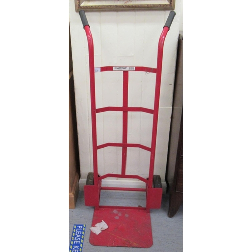 339 - A red painted metal sack barrow with solid tyres 