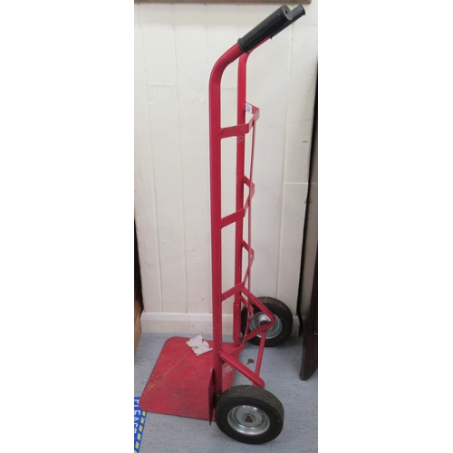 339 - A red painted metal sack barrow with solid tyres 