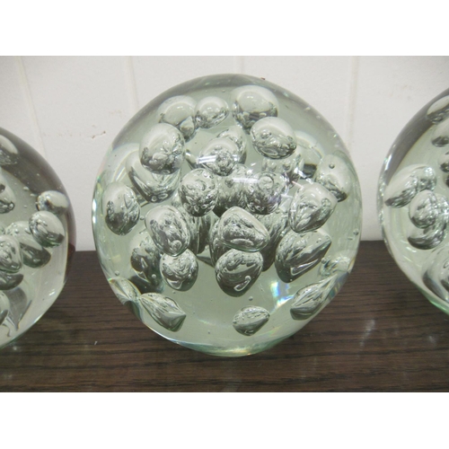 67 - A set of four clear glass door stops with interior bubbled ornament  5