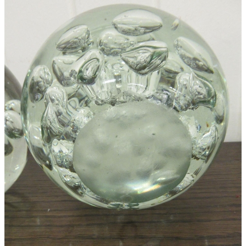 67 - A set of four clear glass door stops with interior bubbled ornament  5