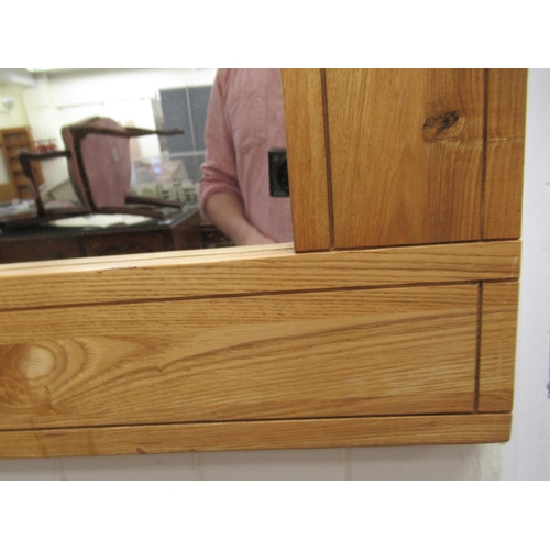 73 - A modern light oak framed mirror with a plain plate  28