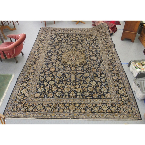 191 - A Keshan carpet, decorated with dense floral motifs, on a blue ground  157