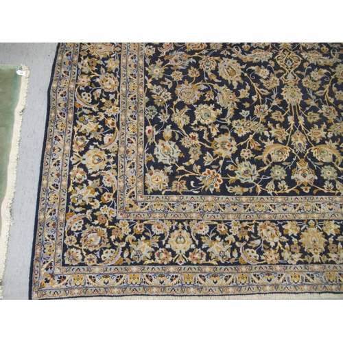 191 - A Keshan carpet, decorated with dense floral motifs, on a blue ground  157