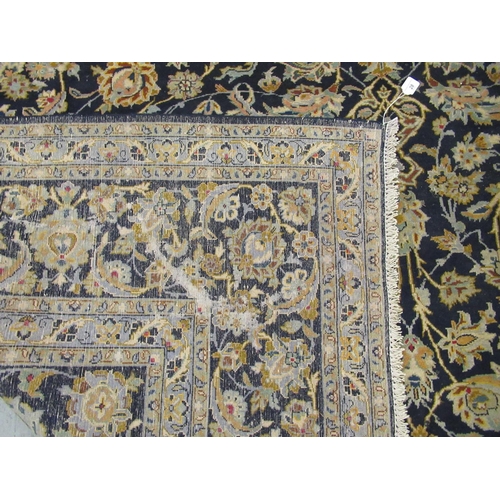 191 - A Keshan carpet, decorated with dense floral motifs, on a blue ground  157