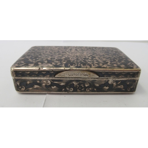 104 - An early/mid 20thC Russian silver snuff box, profusely decorated with nielloworked foliage  bears '8... 