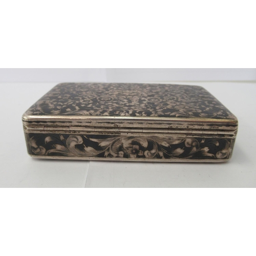 104 - An early/mid 20thC Russian silver snuff box, profusely decorated with nielloworked foliage  bears '8... 