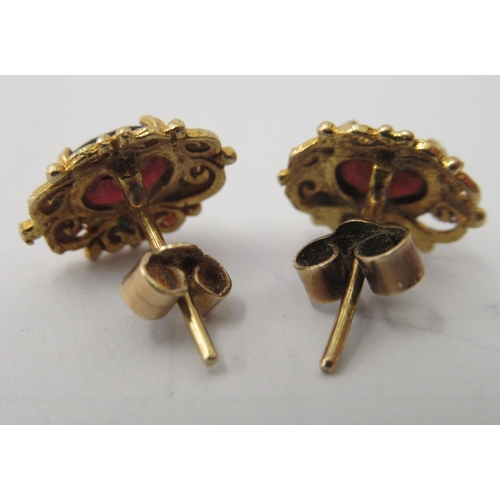 107 - A pair of 9ct gold rings, claw set, garnets