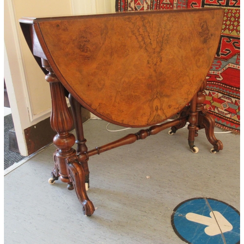 152 - A late Victorian walnut Sutherland table, the quartered and figured oval top, raised on tulip carved... 