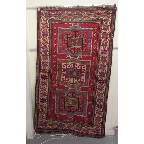 178 - An Afghan Kazak rug, decorated with repeating geometric designs, on a cream ground  52