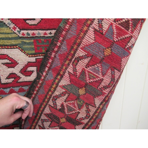 178 - An Afghan Kazak rug, decorated with repeating geometric designs, on a cream ground  52