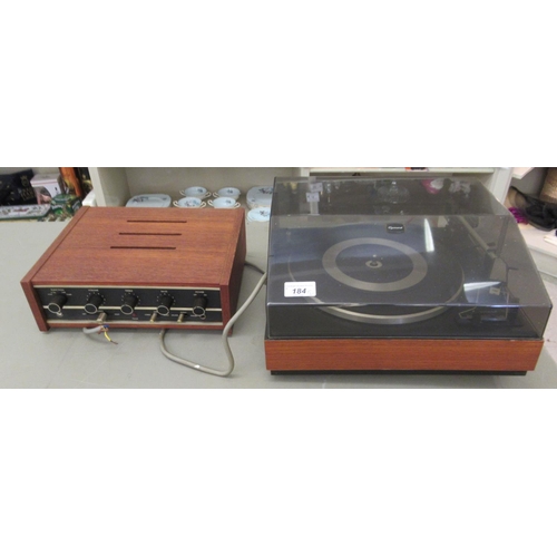 184 - A Garrard record deck, in a teak case; and an Eagle amp, in a teak case