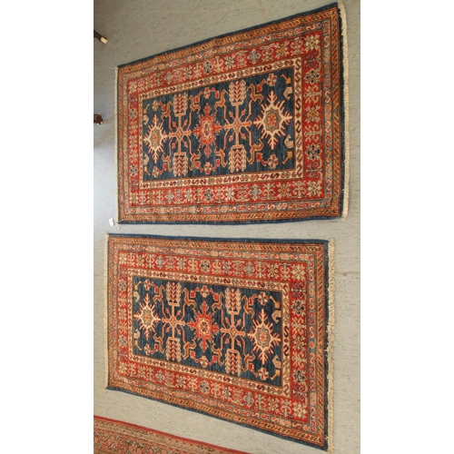 192 - A pair of Persian rugs, decorated with stylised designs, on a multi-coloured ground  30