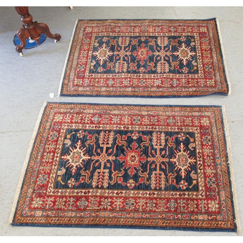 192 - A pair of Persian rugs, decorated with stylised designs, on a multi-coloured ground  30