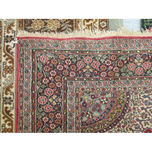 181 - A Persian rug, decorated with a central starburst design medallion, bordered by floral designs, on a... 