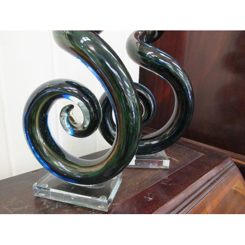 140 - A pair of modern green, blue and brown drawn glass table ornaments of tapered, scrolled design  23