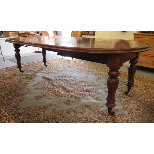 181 - A late Victorian mahogany wind-out dining table, raised on octagonal, fluted legs and casters  29